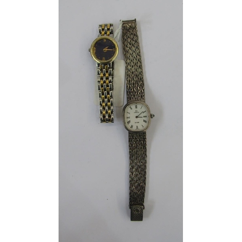 584 - Lady’s Omega stainless steel wristwatch with blue face and a lady’s silver Omega wristwatch (2)