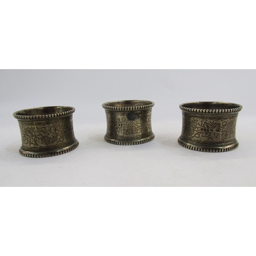 268 - Set of three Victorian silver napkin rings, London 1875, William Evans, with gadrooned edge, foliate... 