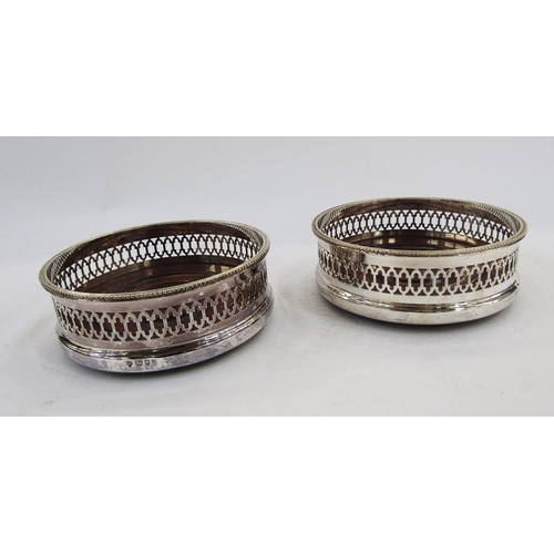 278 - Pair of matching silver and mahogany bottle coasters, London 1988, C J Vander Ltd, each with gadroon... 