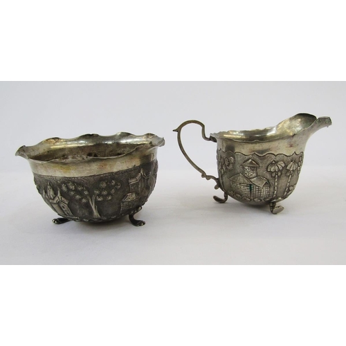 306 - Foreign silver sugar basin and matching cream jug with scalloped inverted rim repousse decoration wi... 