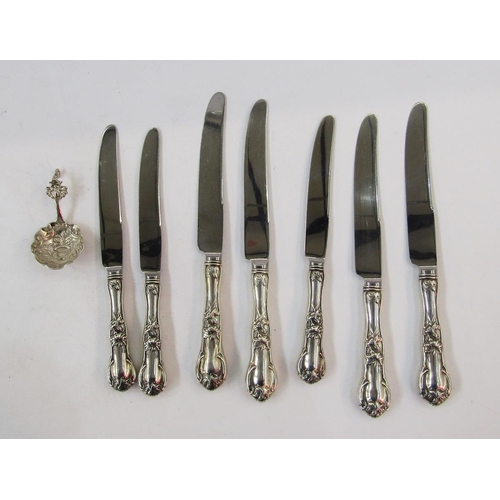 308 - Seven sterling handled knives, floral and scroll decorated, and continental silver small caddy spoon... 