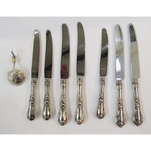 308 - Seven sterling handled knives, floral and scroll decorated, and continental silver small caddy spoon... 