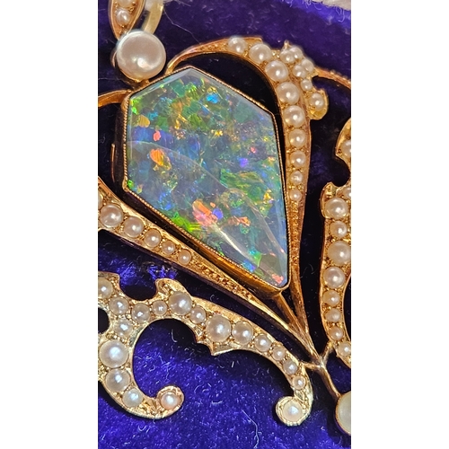 512 - Edwardian gold pendant brooch, the central lozenge-shaped opal (possibly a doublet) within a scrolli... 