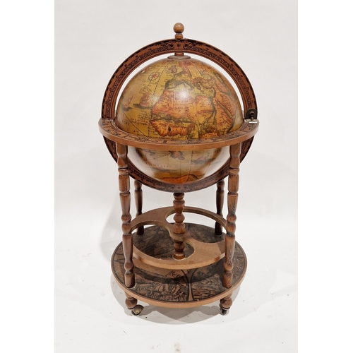 1053 - 20th century Italian style terrestrial globe cocktail cabinet, the hinged lid opening to a fitted in... 