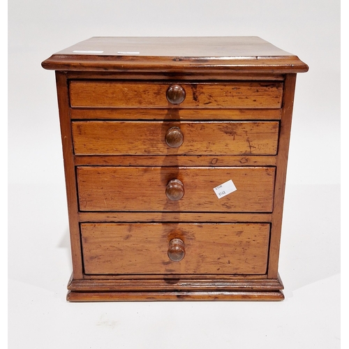 1054 - 19th century stained pine table top collector's cabinet, the four graduated drawers with turned wood... 