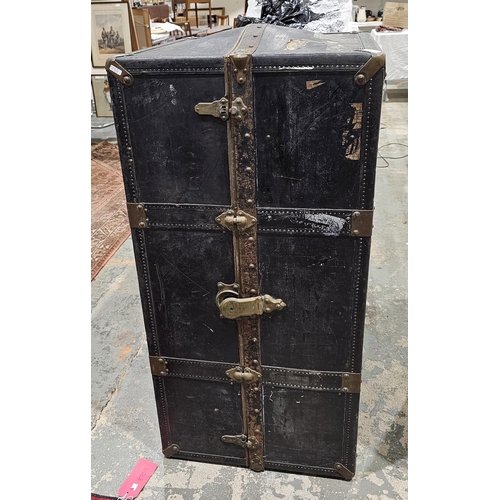 1121 - Early 20th century metal bound travelling wardrobe trunk, with leather handles, opening to an interi... 