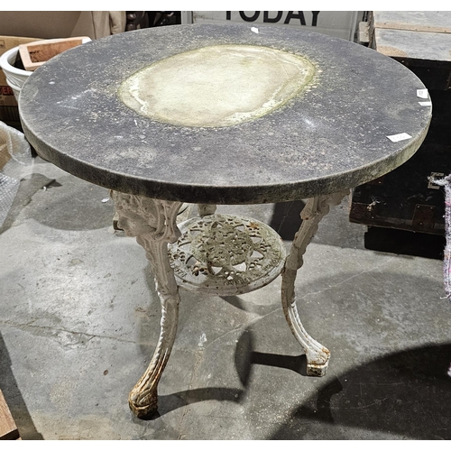 1123 - Circular marble top table, the ornate iron base with three legs cast with face masks, 71cm diameter ... 