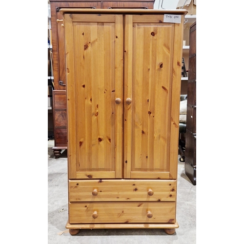 1124 - Modern small pine wardrobe with two doors opening to a hanging space and two long drawers below, on ... 