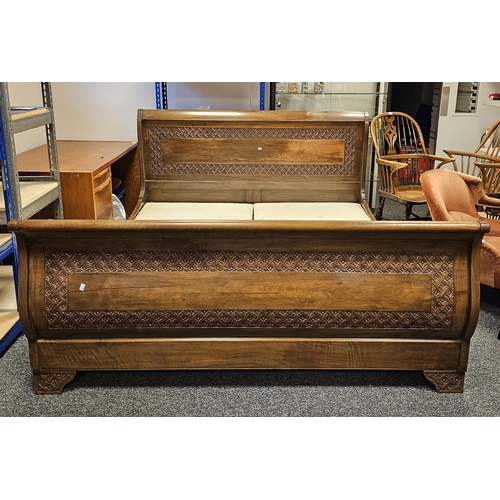 1153 - Simon Horn stained wooden superking sleigh bed with carved floral motifs to headboard, footboard and... 