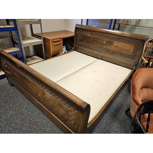 1153 - Simon Horn stained wooden superking sleigh bed with carved floral motifs to headboard, footboard and... 