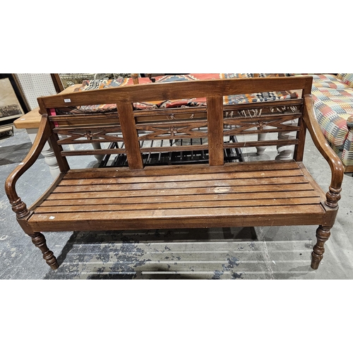 1170 - Stained hardwood garden/conservatory bench with carved floral splats and slatted seat base, raised o... 