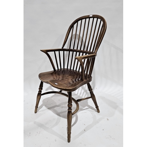 1189A - Elm seated and ash Windsor hoop and comb back elbow chair with saddle seat, on turned legs united by... 