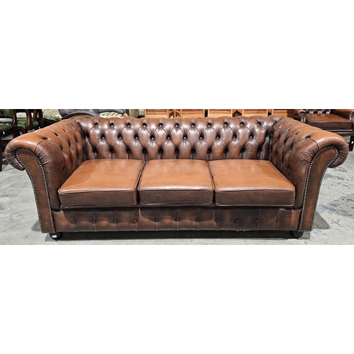 1194 - Office reception chesterfield style brown buttoned leather three seater sofa with brass studding, on... 