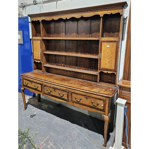 1215 - George III oak and walnut dresser, with shell and checker board string inlay, the moulded and shaped... 