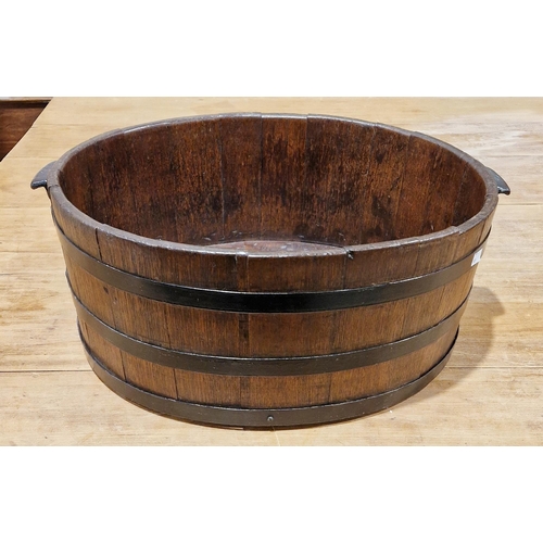 160A - 19th century coopered oak two-handled oval tub, with studded iron banding and handles, 60cm wide