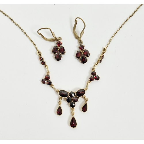 203 - 10k yellow gold and garnet link necklace, set with round, oval and drop pear-shaped garnets, togethe... 