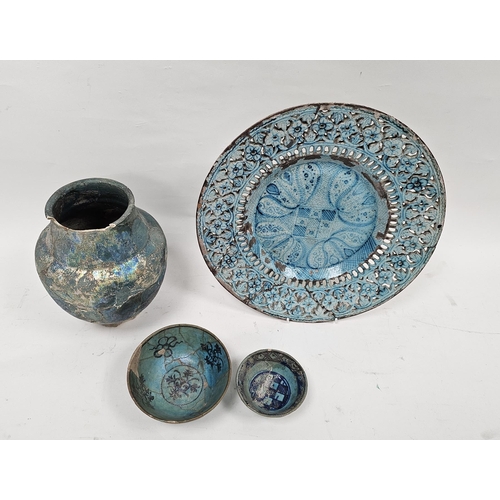 26 - Group of Persian turquoise glazed pottery to include an Iranian 18th-19th century pierced charger, t... 