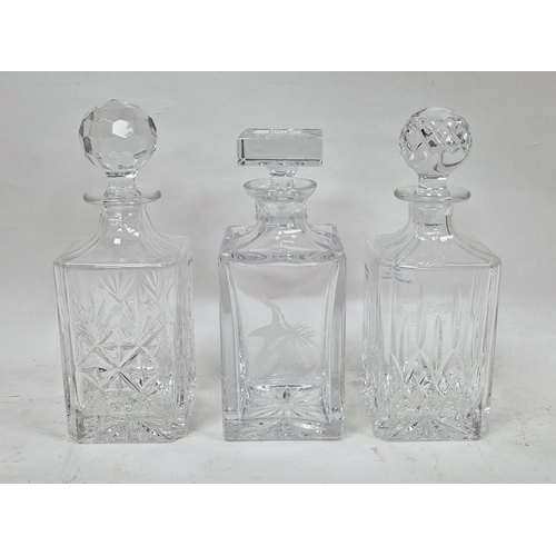 40 - Three contemporary square-section glass whisky decanters and stoppers, comprising an example engrave... 