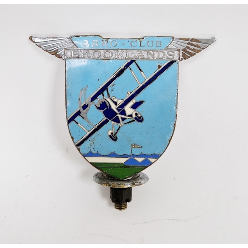 159 - Brooklands Aero-club enamel car mascot depicting a bi-plane in flight, stamped to reverse Spencer, L... 