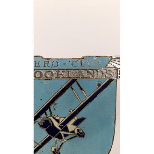 159 - Brooklands Aero-club enamel car mascot depicting a bi-plane in flight, stamped to reverse Spencer, L... 