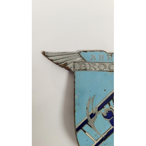 159 - Brooklands Aero-club enamel car mascot depicting a bi-plane in flight, stamped to reverse Spencer, L... 