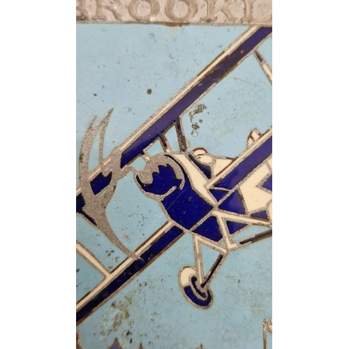 159 - Brooklands Aero-club enamel car mascot depicting a bi-plane in flight, stamped to reverse Spencer, L... 