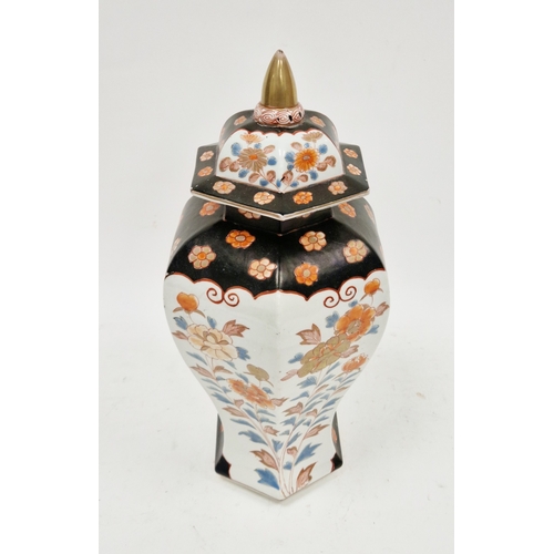 131 - Imari inverted baluster faceted section vase and domed cover, painted in iron red, blue and gilding ... 