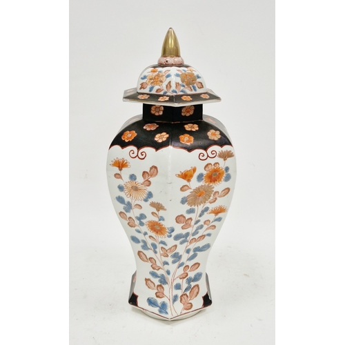131 - Imari inverted baluster faceted section vase and domed cover, painted in iron red, blue and gilding ... 