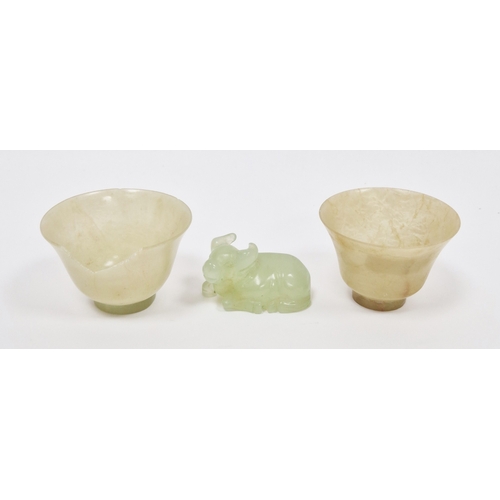 136 - Two Chinese carved pale jade cups, each of flared footed form, 2.3cm high x 5.7cm diameter (some dam... 