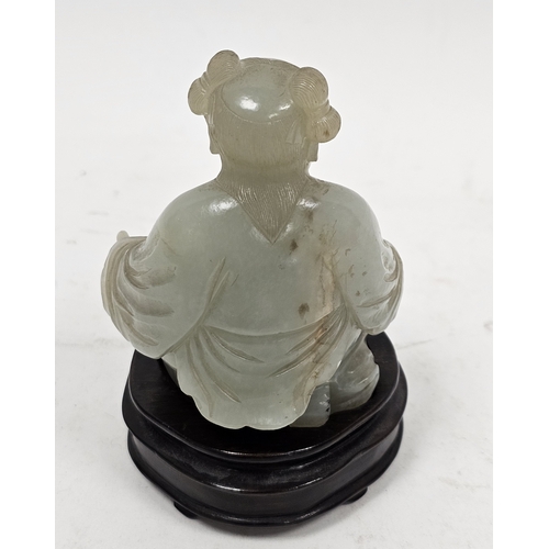 137 - Chinese carved pale celadon jade model of a kneeling boy on wooden stand, Qing Dynasty, with his lef... 