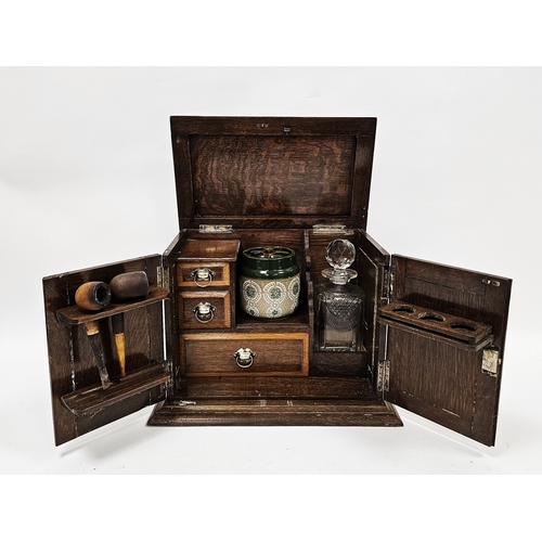 159 - Early 20th century oak smoker's cabinet, the two panel doors opening to an interior fitted with draw... 