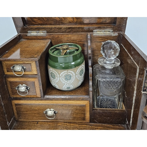 159 - Early 20th century oak smoker's cabinet, the two panel doors opening to an interior fitted with draw... 