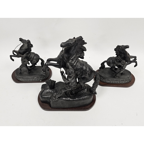 163 - Pair of spelter Marley horses on mahogany oval plinths, 23cm high and a single spelter Marley horse ... 