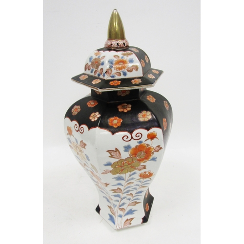131 - Imari inverted baluster faceted section vase and domed cover, painted in iron red, blue and gilding ... 