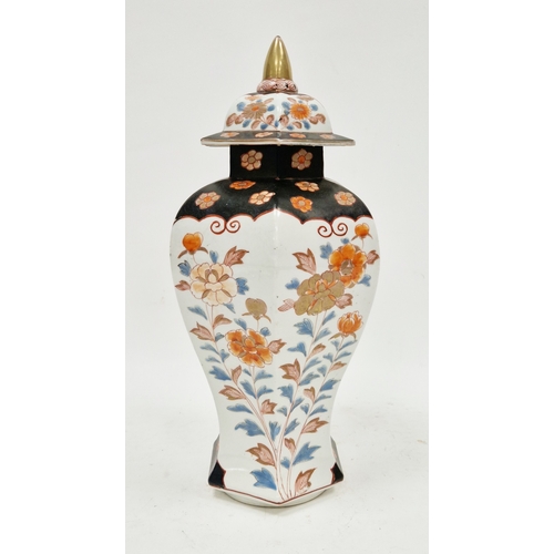131 - Imari inverted baluster faceted section vase and domed cover, painted in iron red, blue and gilding ... 