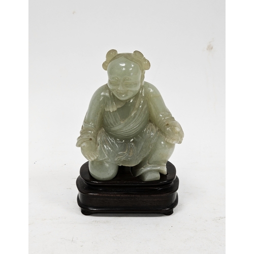 137 - Chinese carved pale celadon jade model of a kneeling boy on wooden stand, Qing Dynasty, with his lef... 