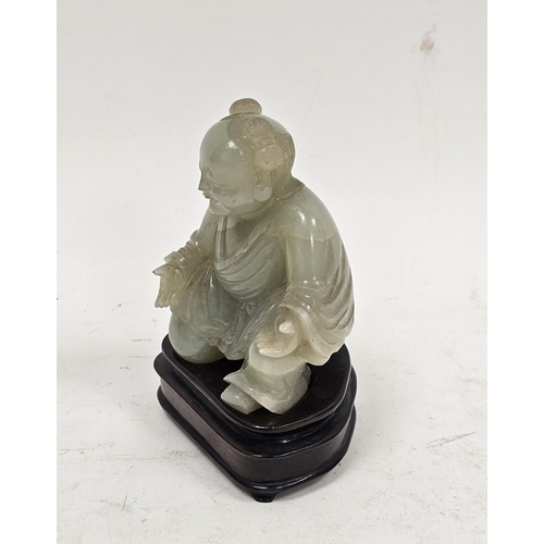 137 - Chinese carved pale celadon jade model of a kneeling boy on wooden stand, Qing Dynasty, with his lef... 