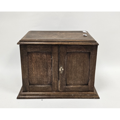 159 - Early 20th century oak smoker's cabinet, the two panel doors opening to an interior fitted with draw... 