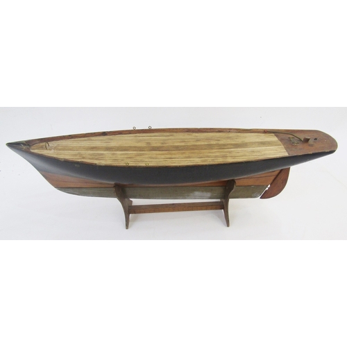 122 - Vintage wooden pond yacht with weighted base and rudder, 56cm long on stained wood stand