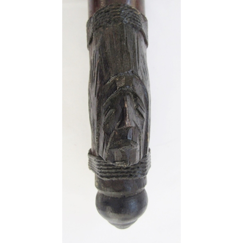 148 - Javanese Kris with carved handle, decorative blade and carved scabbard, together with a blowpipe and... 