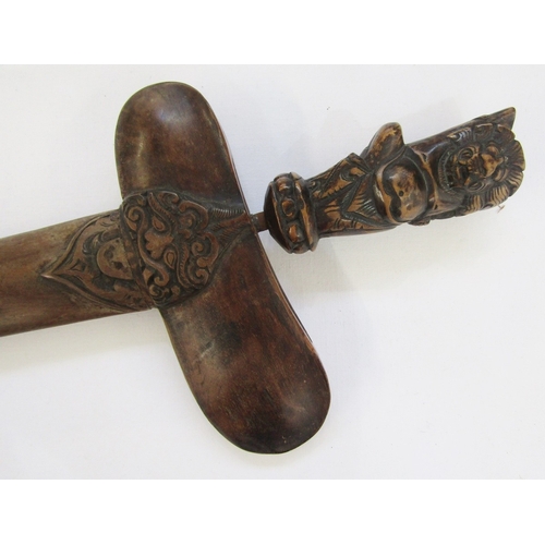 148 - Javanese Kris with carved handle, decorative blade and carved scabbard, together with a blowpipe and... 