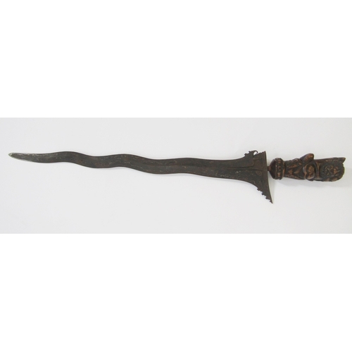 148 - Javanese Kris with carved handle, decorative blade and carved scabbard, together with a blowpipe and... 