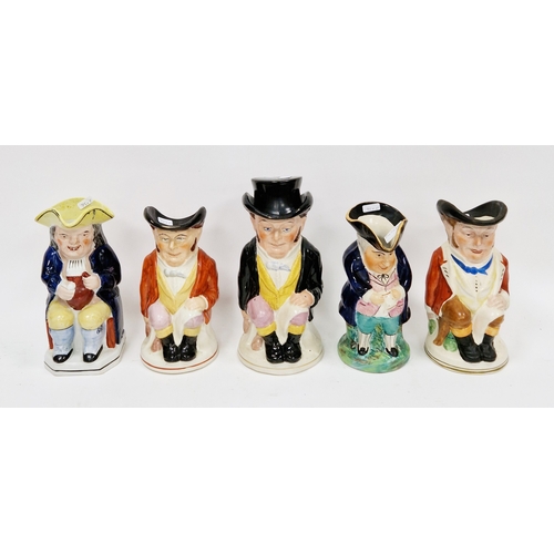 75 - Five Staffordshire pottery toby jugs, comprising: a 19th century toby seated with a yellow hat, hold... 