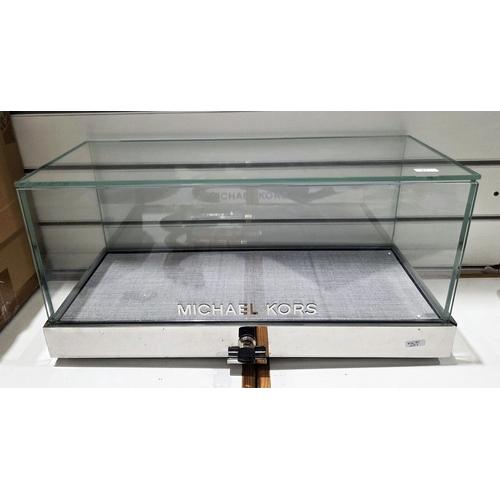 182 - Contemporary Michael Kors counter top shop display cabinet of rectangular form, comprising five glas... 