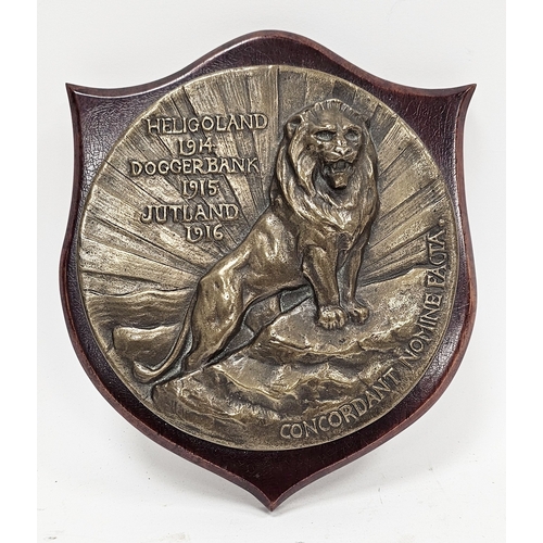 196 - World War I circular bronze badge plaque relating to HMS Lion, decorated in relief with a lion and t... 
