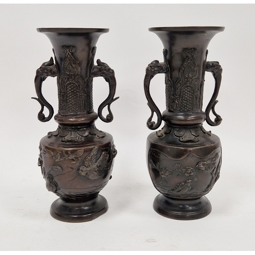 114 - Two Japanese bronze vases, 20th century, cast with birds perched among flowering prunus, with beast ... 