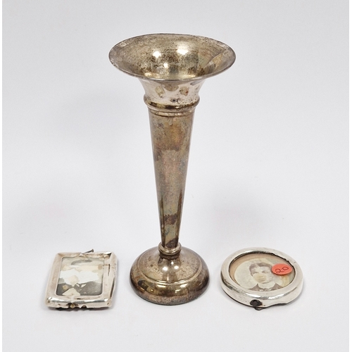 312 - Small silver vase of trumpet shape (weighted base) and two miniature silver photograph frames (unmar... 