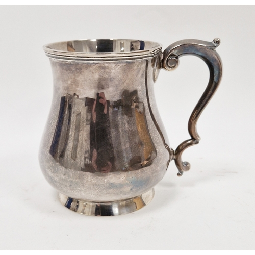 320 - Silver mug by Martin Hall & Co, Sheffield 1923, of plain baluster form with scroll handle, 12cm high... 