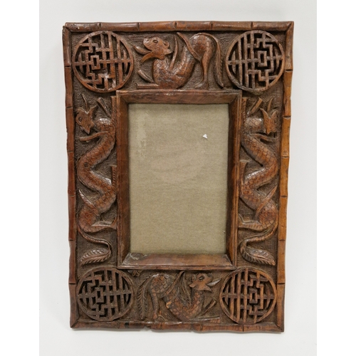 96 - Carved Chinese wooden picture frame, circa 1900, carved with scrolling serpent like beasts and styli... 