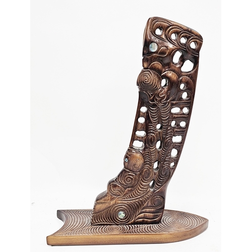 141 - Replica Maori Waka wooden stem or stern post, carved with figures having mother of pearl eyes, label... 